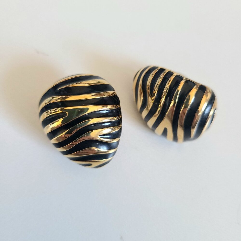 Joan Rivers large gold black enamel clip on earrings with animal design.